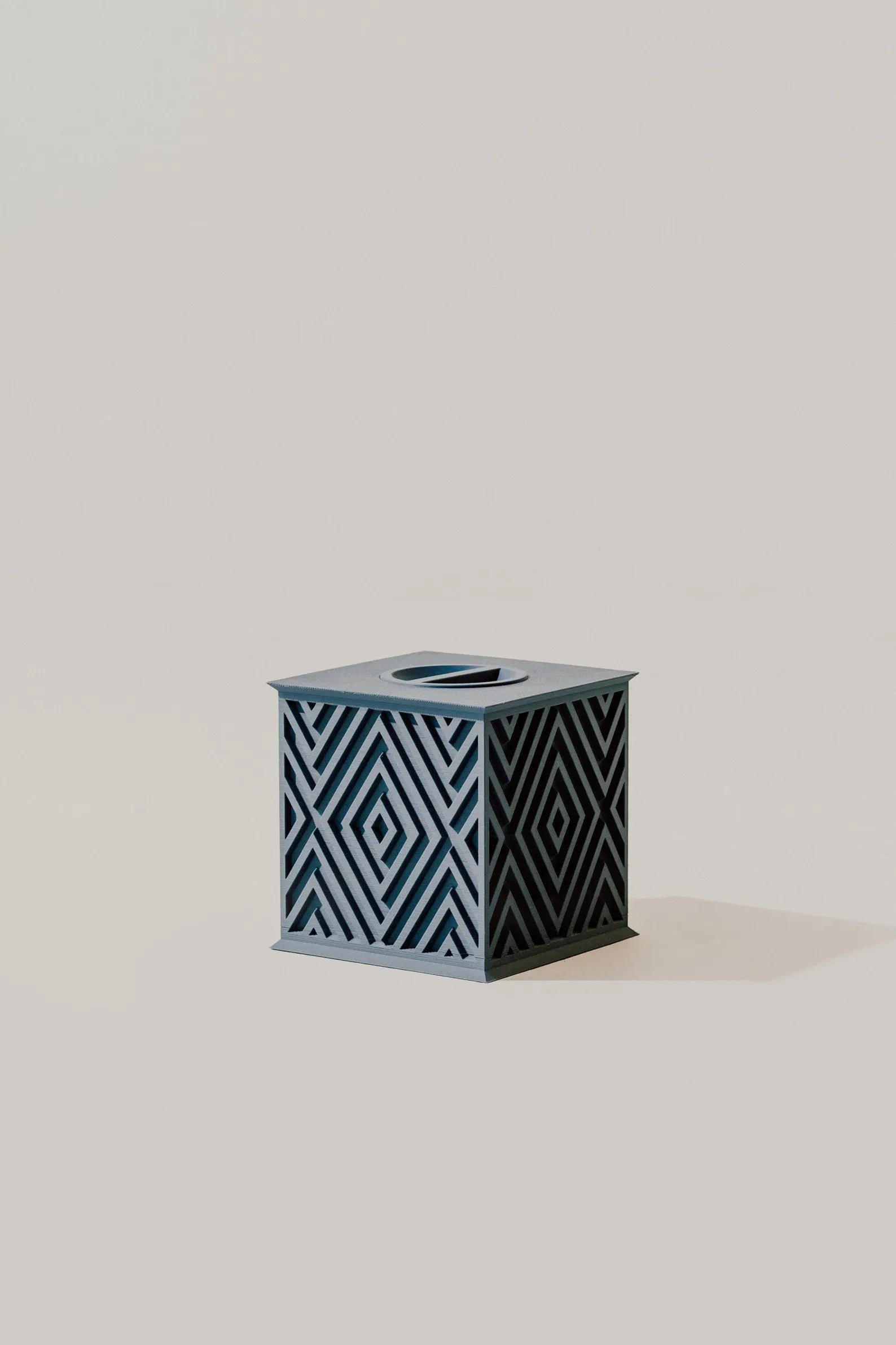 Beautiful memorial urn with geometric pattern on a light gray background