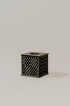 Beautiful black memorial urn with geometric pattern on a light gray background