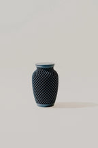 Dark blue textured memorial urn on a light gray background