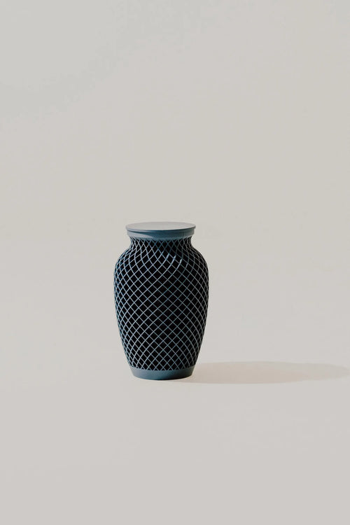 Dark blue textured memorial urn on a light gray background