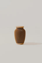Woven texture memorial urn with geometric pattern on a light background