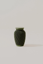 Green woven texture memorial urn with geometric pattern on a light background